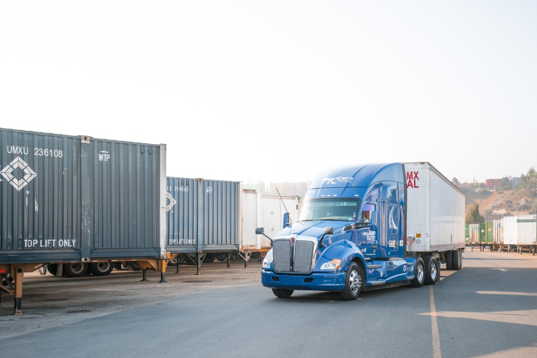 Blue truck on a lot.