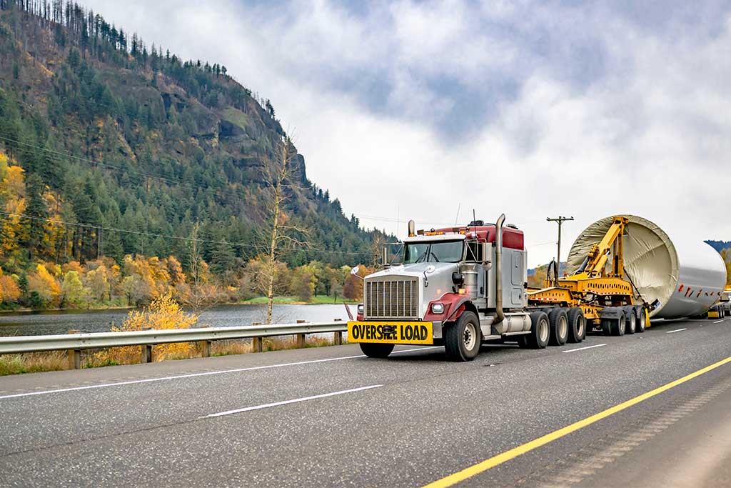 truck on the road transporting heavy equipment