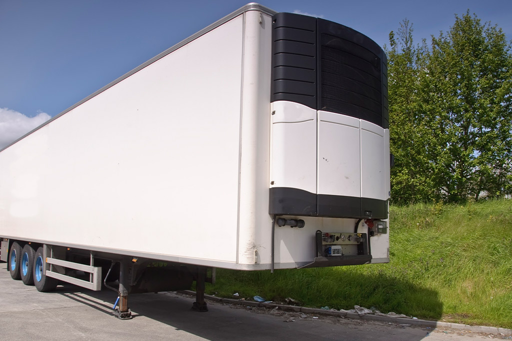 A white semi truck parked on the side of the road, emphasizing the importance of cold chain logistics in summer.