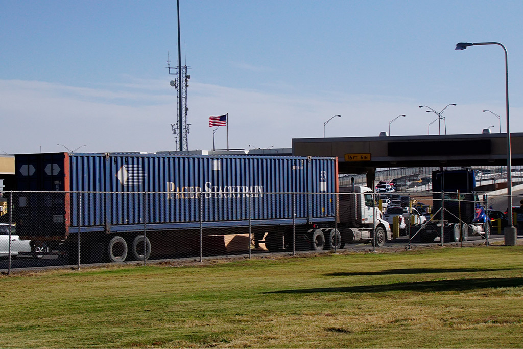 A blue truck towing a trailer, representing essential practices for food transport on Tijuana-San Diego routes.