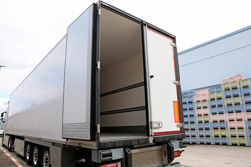 A large truck with its door open, ready for loading, symbolizing cross-border food transport between Tijuana and San Diego.